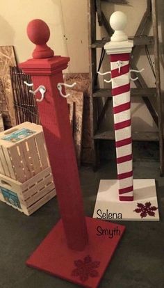 two red and white poles are on display in a room with other items behind them