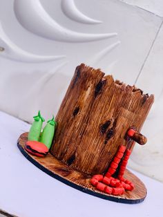 a cake made to look like a tree stump with red and green decorations on it