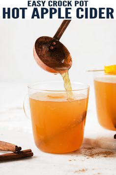 an apple cider being poured into a cup