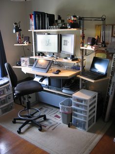 a computer desk with two computers on top of it