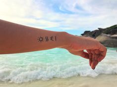 a person's arm with the word omei written on it in black ink