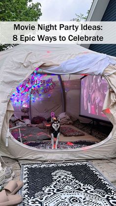 there is a tent with lights on it and a dog standing in the doorway