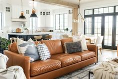 a living room filled with furniture and lots of windows