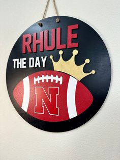 a sign that says,'rhule the day'and a football with a crown on it