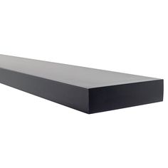 an empty black shelf sitting on top of a white wall in front of a white background