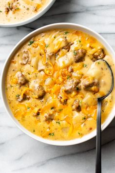 two bowls of soup with meat and cheese