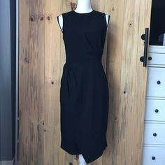 New. Never Worn. Fitted. Zip Closure And Hook-Eye In Back. Lining Top. Material: Shell: 70% Triacetate, 30% Polyester, Lining: 100% Polyester. Flat Measurement: From Front Neck To Hem (Longest Point) Approx. 39 Inches Long. No Trades, No Holds Elegant Midi Dress With Asymmetrical Hem For Work, Elegant Asymmetrical Dress For Work, Chic Asymmetrical Midi Dress For Office, Black Sleeveless Asymmetrical Dress For Work, Chic Asymmetrical Dress For Work, Asymmetrical Sheath Dress For Work, Chic Sleeveless Asymmetrical Dress For Work, Black Midi Dress With Side Zipper, Chic Knee-length Midi Dress With Side Zipper