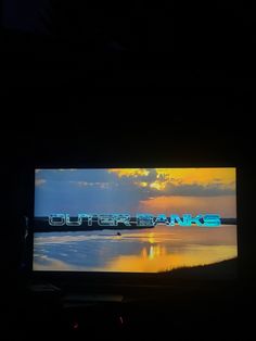 a television screen with the words outer banks on it in front of a dark background