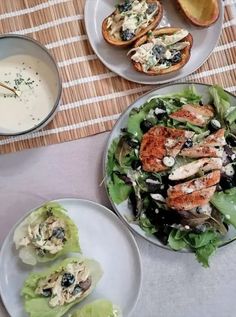 three plates with food on them sitting on a table