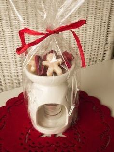 a cup filled with cookies sitting on top of a red doily