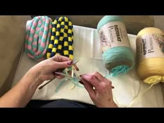 a woman is working on some crafting items with yarn and scissors in her hands