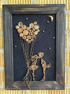 a shadow frame with buttons and flowers in it