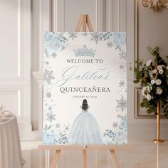 a welcome sign for quincaanera in front of a white room with flowers