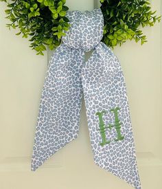 a door hanger with a monogrammed wreath on it