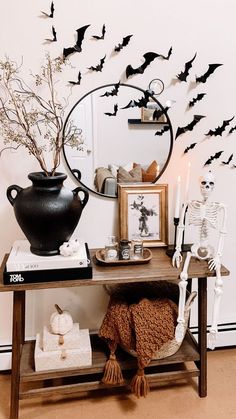 a table topped with a vase filled with halloween decorations