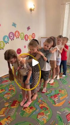 children are playing with hoop toys in the room