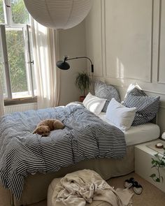 a dog laying on a bed in a bedroom