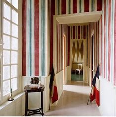 the hallway is decorated with red, white and blue striped wallpaper