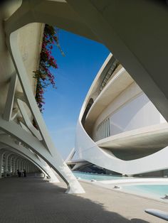 an architectural building with flowers growing out of it's roof and walkways on both sides