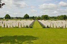 rows of white headstones in a grassy field