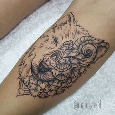 a close up of a person's leg with a tattoo on the arm and an animal