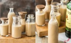 several bottles filled with liquid sitting on top of a wooden table