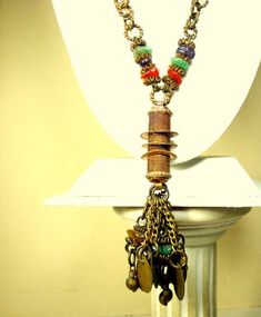 "Lariat Chain Necklace, Tribal India 1960s Coppery Brass w Gemstone Nuggets & Coins, Darkened and Moody From Age Something Old Jewelry, a Primitive Tribal Personal Piece Do not wear on a white shirt The Long coin chain Tassel Necklace is 28\" to the top of the tassel ( 71.12cm ) the Tassel is 4\" long by 2\" wide ( 10.16cm x 5.08cm ) all tarnished from age, ---------------------------------------------------------------------------- PLEASE NOTE I ONLY ship to your paid ETSY invoice address, Vintage Metal Dangle Beaded Necklaces, Adjustable Bohemian Jewel Necklaces, Adjustable Bohemian Jewel Necklace, Bohemian Adjustable Jeweled Necklaces, Bohemian Adjustable Jewel Necklaces, Multicolor Bohemian Jewelry With Vintage Charm, Multicolor Bohemian Vintage Charm Jewelry, Bohemian Multicolor Vintage Charm Jewelry, Bohemian Brass Necklaces With Jewels