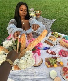 a woman sitting at a table covered in food