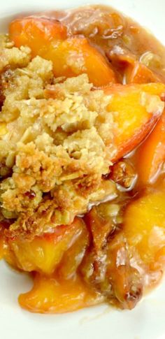 a close up of a plate of food with peaches and crumbled toppings