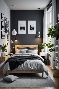 a bedroom with black walls and white bedding, two pictures hanging on the wall