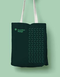 a green tote bag hanging on a wall with the words founder's exchange