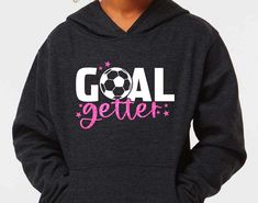 "An adorable and popular soccer hoodie for our \"goal getting\" soccer girls! You can personalize with her choice of glitter (or solid) colors and includes a name on the back or sleeve. C U S T O M I Z E * Goal will be either in white for all dark colored hoodies & black for the light grey hoodie. * You can choose your glitter color for the stars & \"getter\". I can also swap for no glitter as well, see color options in the listing photos. * Listing includes one name either down the sleeve or on Soccer Sweatshirt, Light Grey Hoodie, Soccer Hoodies, Hoodies Black, Goal Getter, Soccer Gifts, Girls Soccer, Soccer Girl, Soccer Mom