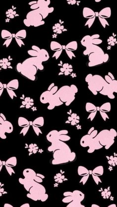 a black background with pink and white rabbits on it's side, all over