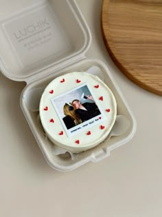 a cake in a box with a photo inside