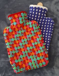 two crocheted oven mitts sitting next to each other on a gray surface