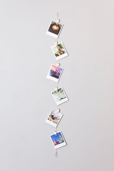 several pictures hanging from the side of a white wall