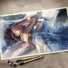 a watercolor painting of a naked woman laying on a bed next to paintbrushes