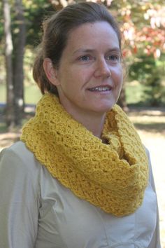 a woman wearing a yellow crocheted cowl