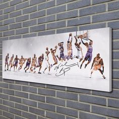 an autographed photo of the los angeles lakers basketball team hanging on a brick wall