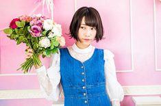 a young woman holding a bouquet of flowers