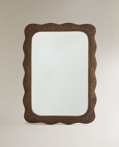 a brown mirror sitting on top of a white wall