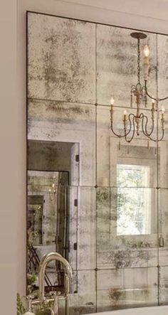 a bathroom with a chandelier hanging from the ceiling next to a bathtub