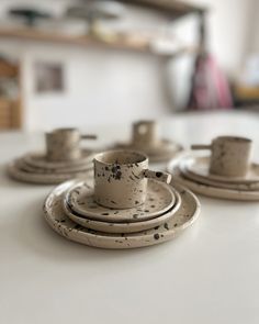 the dishes are sitting on the table ready to be made into cups and saucers