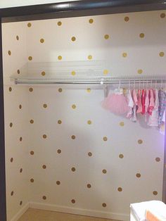 a closet with polka dots on the wall