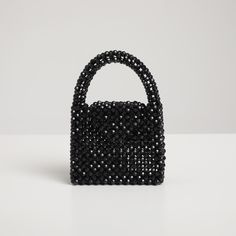 ✮ The Nott Black Crystal Bag, crafted from black crystal beads, reflects the elegance and sophistication of the night  🖤 ✮  The name "Nott" pays homage to the goddess of the night and perfectly captures the bag's refined and striking design. ✮ This chic handbag is an ideal choice for evening events, special occasions, and elegant dinners. ✮   Its crystal details and black color add a touch of sophistication to any outfit and make it a memorable gift for loved ones. Material 🖤   ✮ High-quality Elegant Black Beaded Bags, Beaded Top Handle Evening Bag, Luxury Black Beaded Evening Bag, Glamorous Beaded Evening Bag, Evening Top Handle Bag With Beaded Details, Black Rhinestone Clutch For Party, Black Beaded Evening Bag For Wedding, Elegant Party Bag With Black Beads, Elegant Black Beaded Clutch