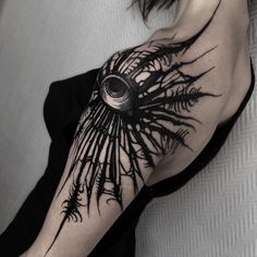 a woman's arm with black ink and an all seeing eye tattoo on it