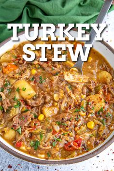 turkey stew in a white bowl with a spoon on the side and green napkin behind it