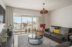 a living room filled with furniture and a flat screen tv