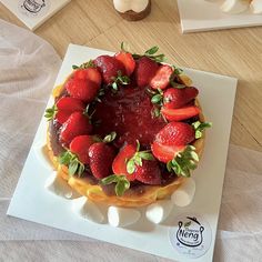 there is a cake with strawberries on it