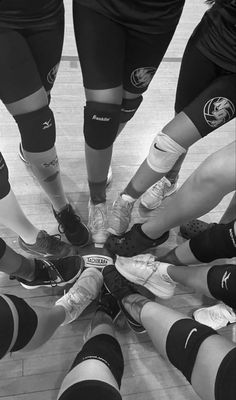 a group of people standing in a circle with their feet together